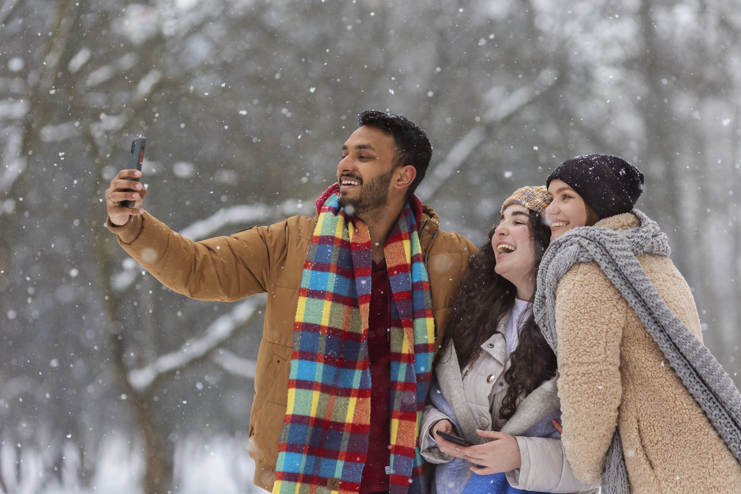 A happy family taking a photo in the snow during winter vacation — representing the best winter holiday destinations in India.