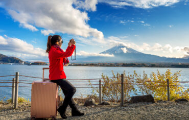 Scenic view of Mount Fuji with cherry blossoms in full bloom, symbolizing the beauty of Japan travel packages.