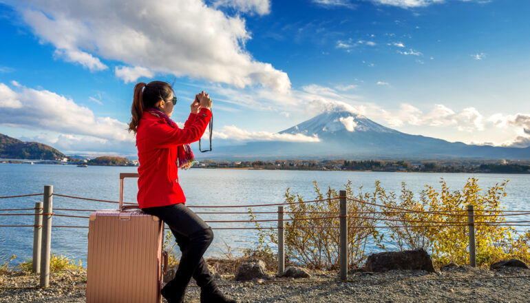 Scenic view of Mount Fuji with cherry blossoms in full bloom, symbolizing the beauty of Japan travel packages.